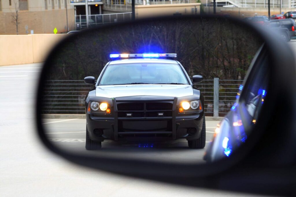Highway patrol in a side mirror pulling you over